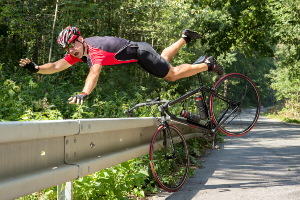 Bicyclist falls off the bike into bushes