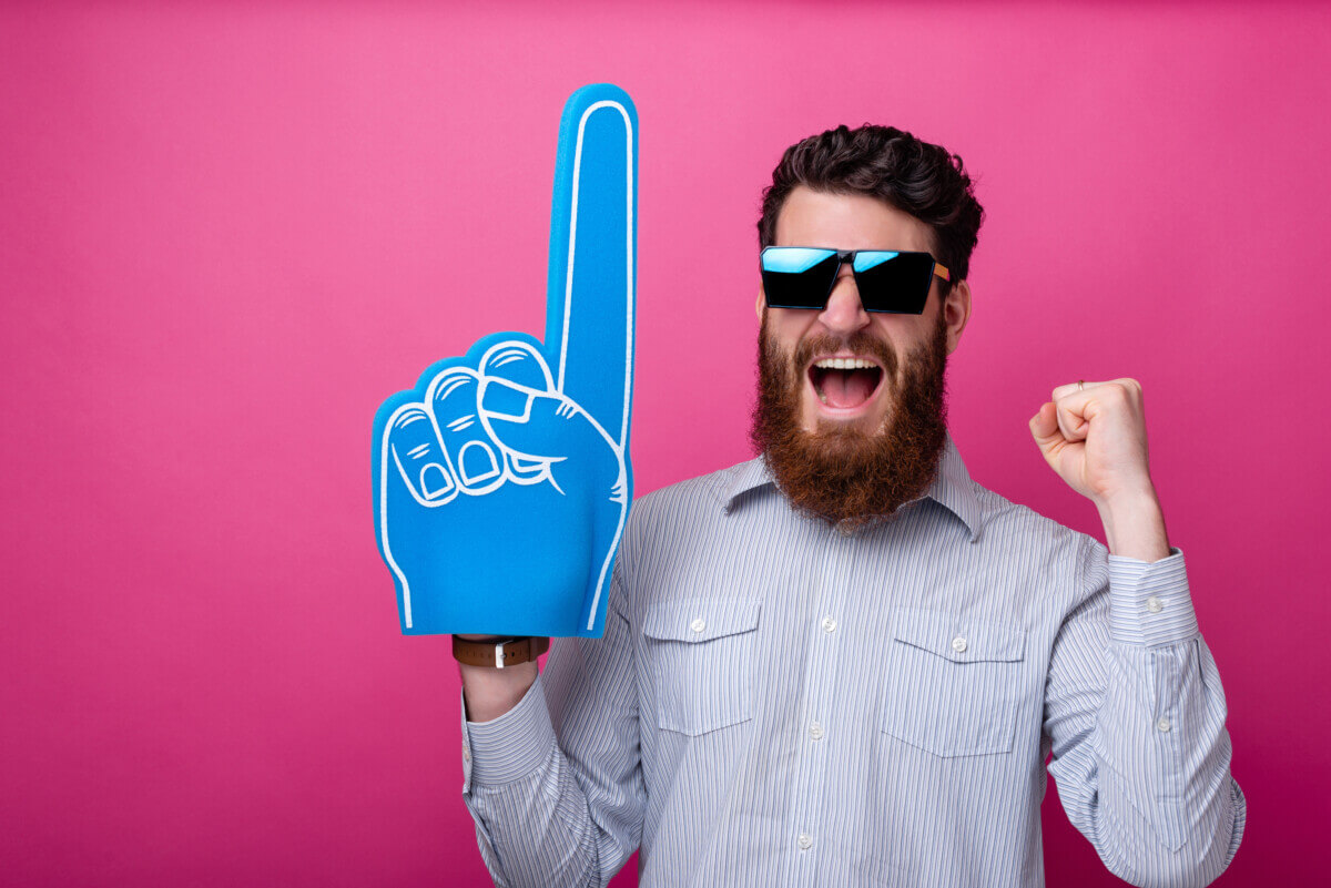 Bearded guy with big blue fan glove, screaming and support his team