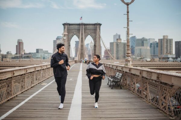 Couple running on the Brooklyn Bridge
