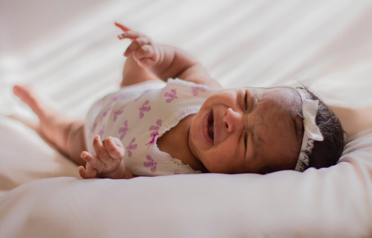 Crying baby in crib