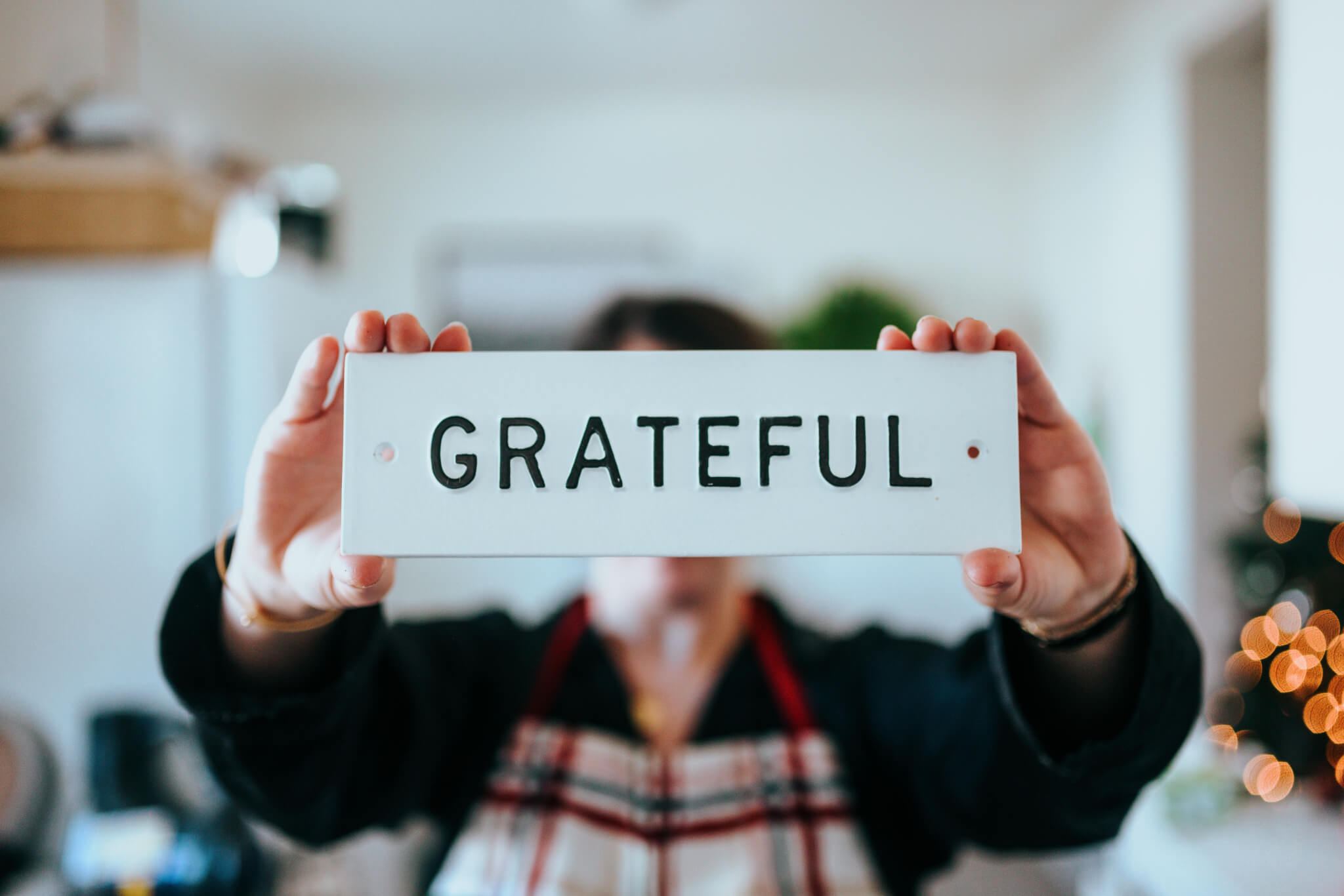 Person holding 'Grateful' sign