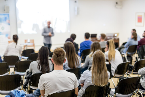 College professor lecturing in lecture hall at university.
