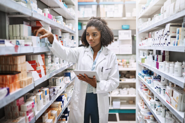Pharmacist checking medication inventory