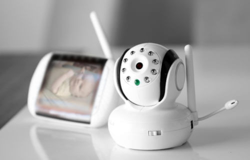 Baby monitor showing infant in crib