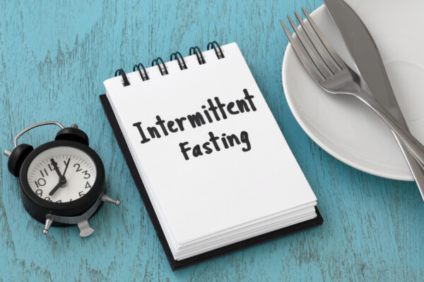 Intermittent fasting concept on blue table
