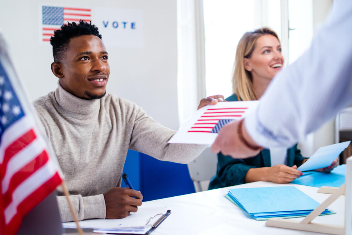 Polling place workers giving voters their ballots on Election Day