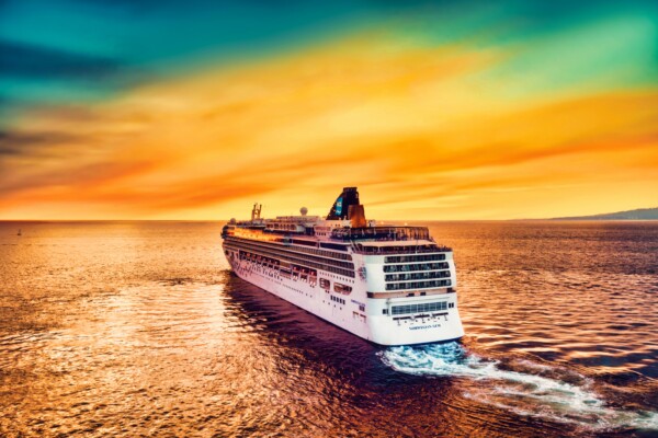 Cruise ship sailing into sunset