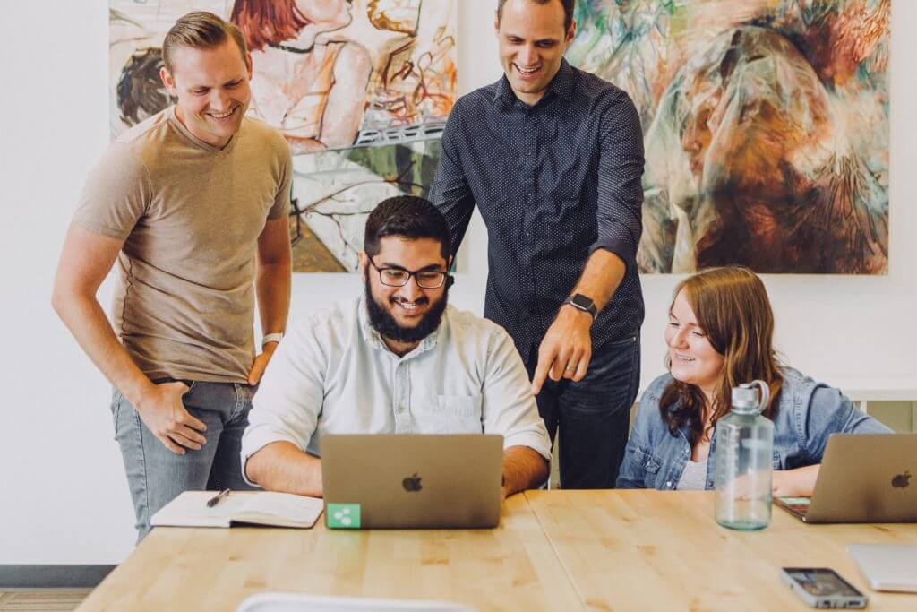 Co-workers laughing, having fun at office meeting