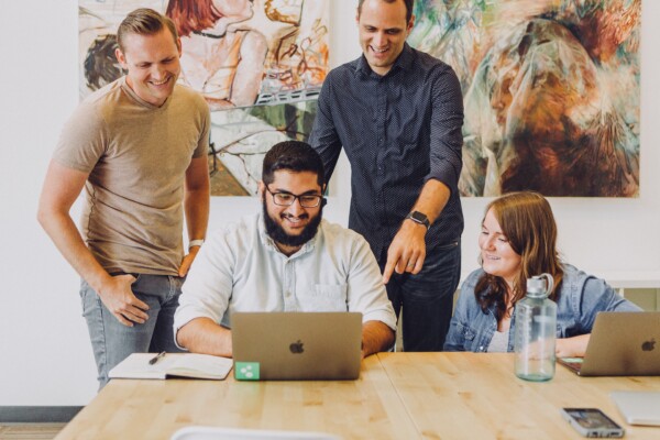 Co-workers laughing, having fun at office meeting