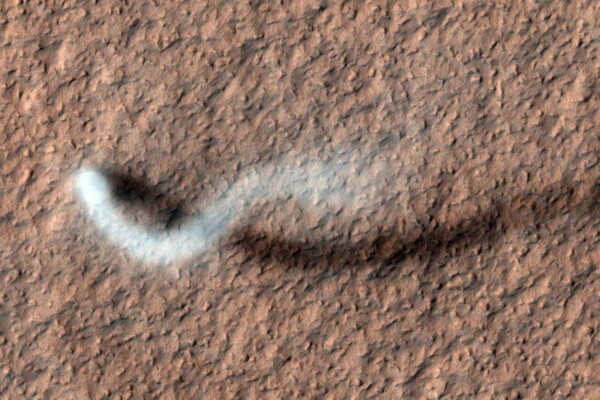 A towering dust devil casts a serpentine shadow over the Martian surface.