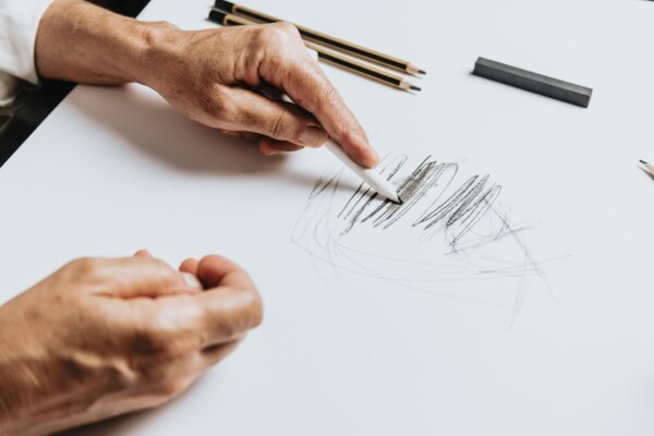 Person drawing on a sketch pad.