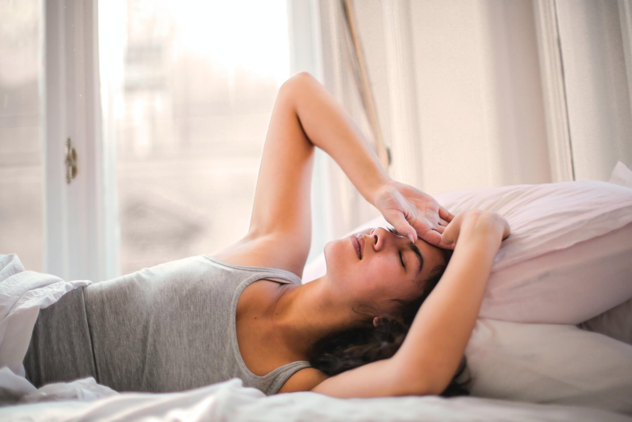 Tired woman in bed struggling to sleep