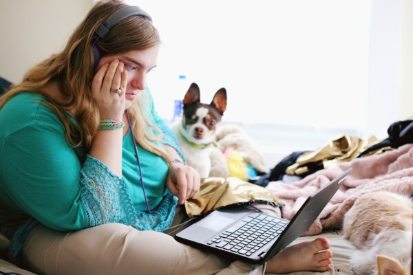 Bored woman looking at laptop computer