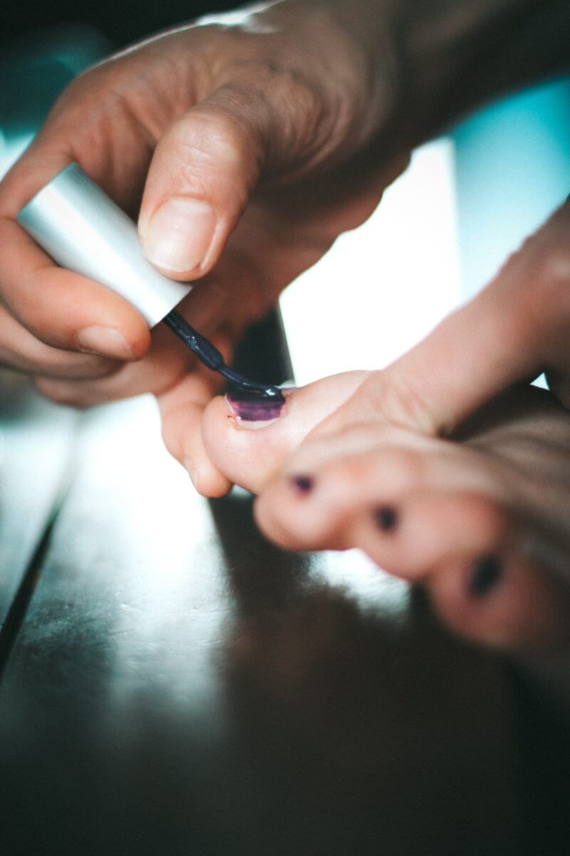Woman painting her toenails