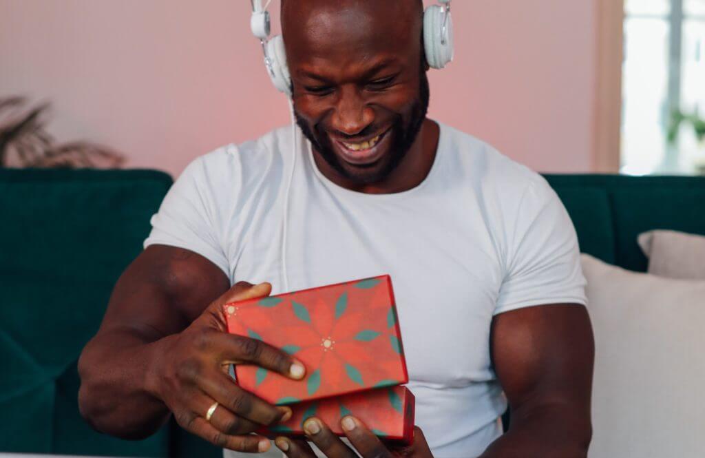 Happy dad opening a Christmas gift