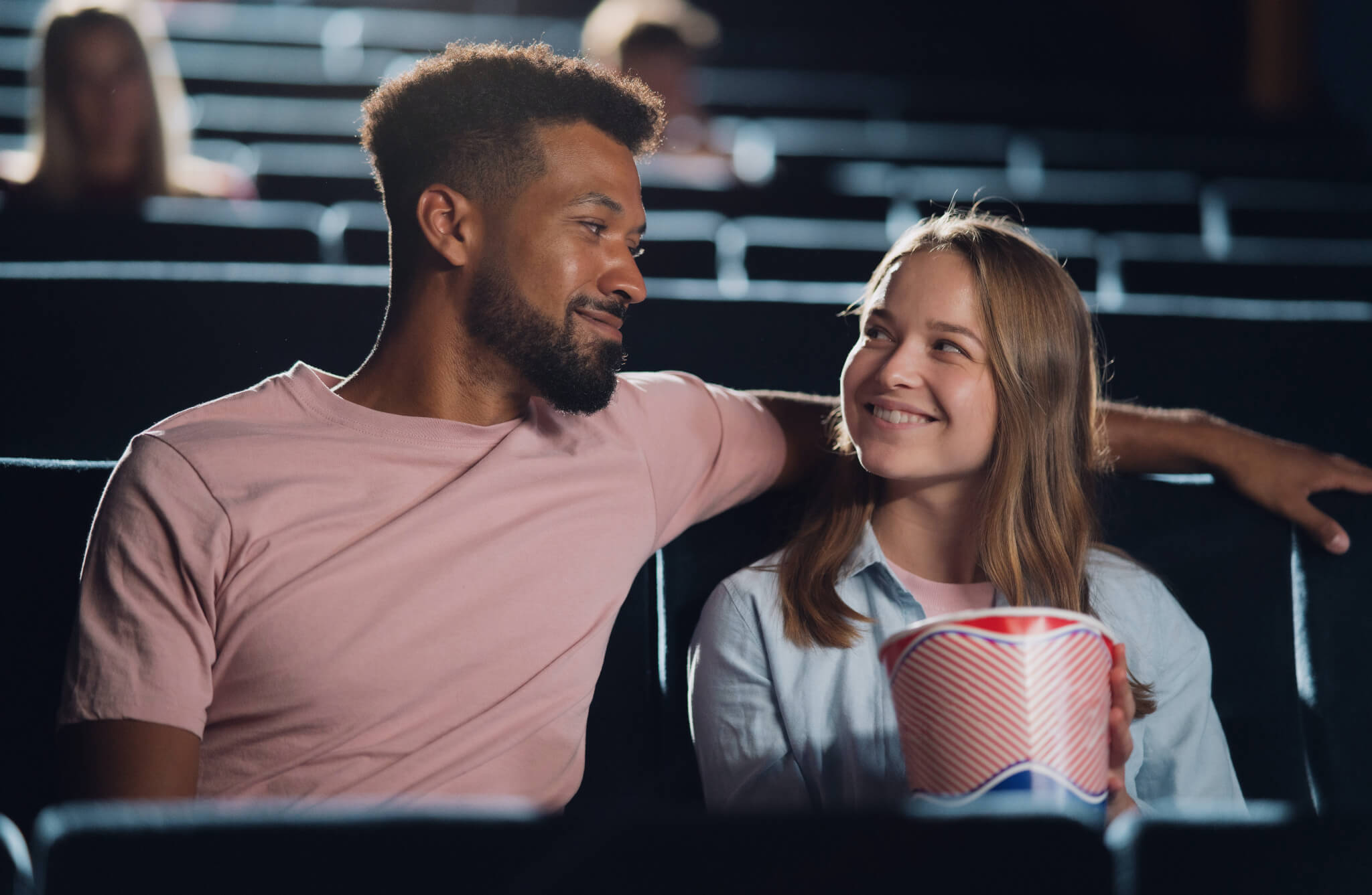 Couple watching a romantic comedy in the movie theater
