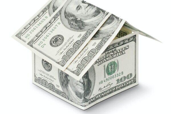 House made from $100 bills, symbolic of housing market.