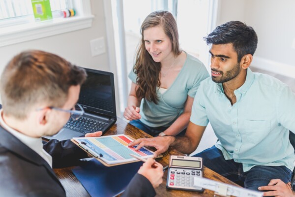 Couple negotiating sale of a new house with a real estate agent