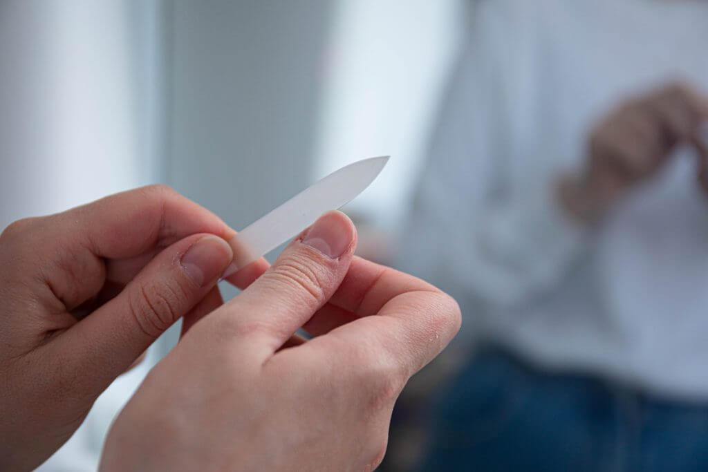 Person filing their nails.