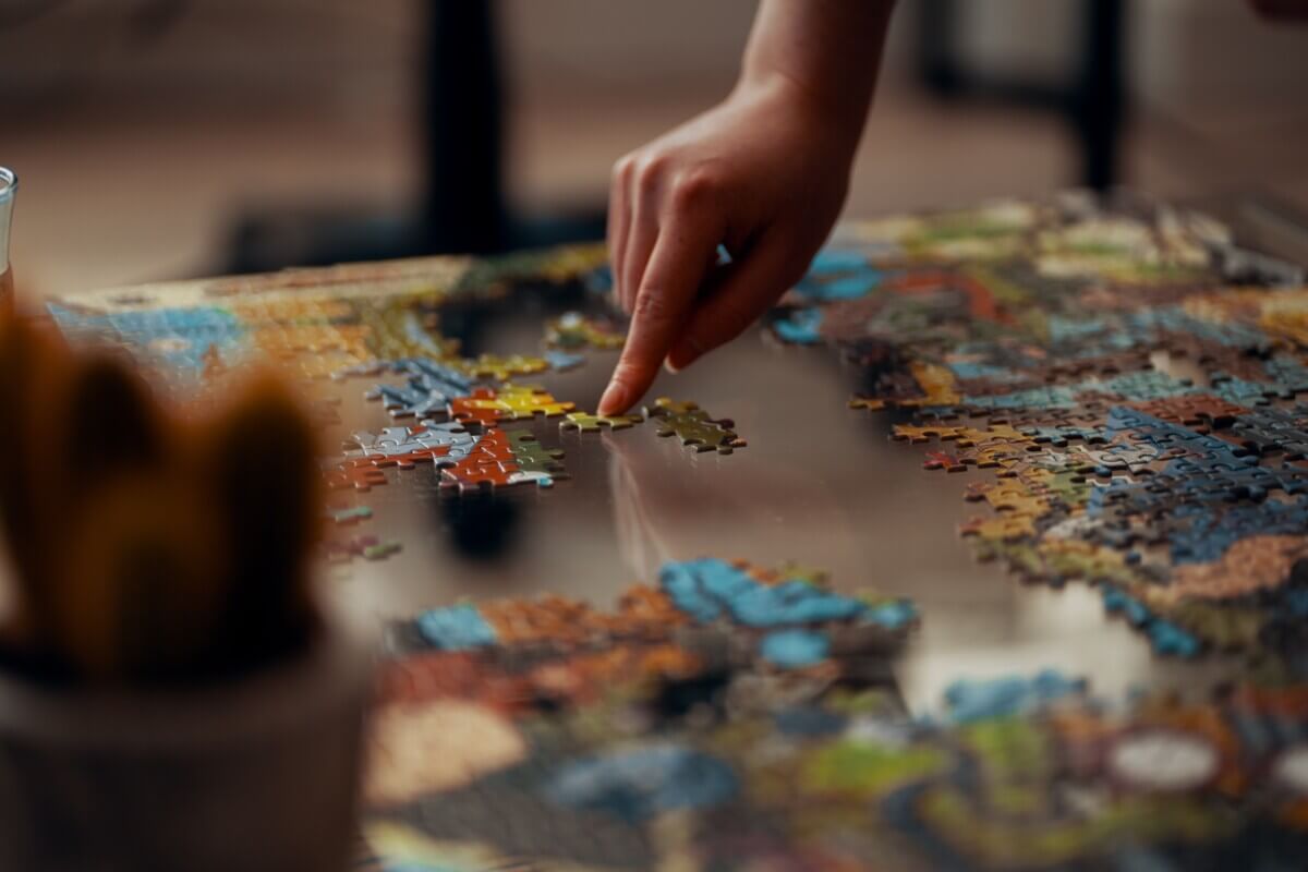 Person working on a jigsaw puzzle