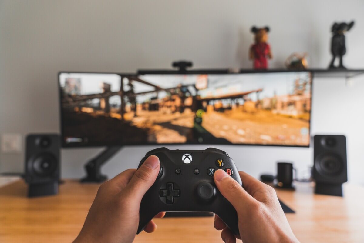 Gamer playing video games on gaming monitor