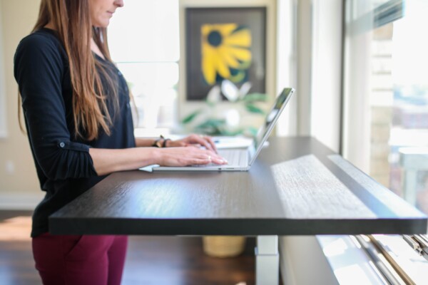 Woman using a standing desk for work.