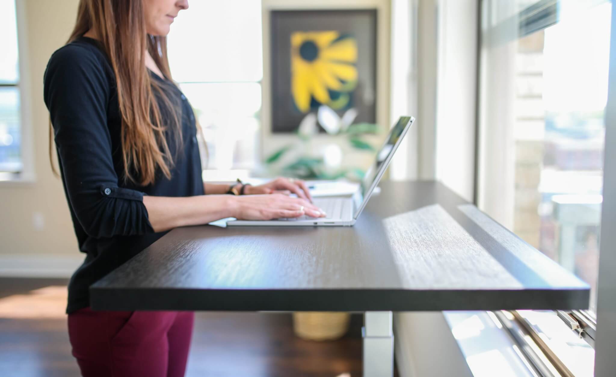 Woman using a standing desk for work.