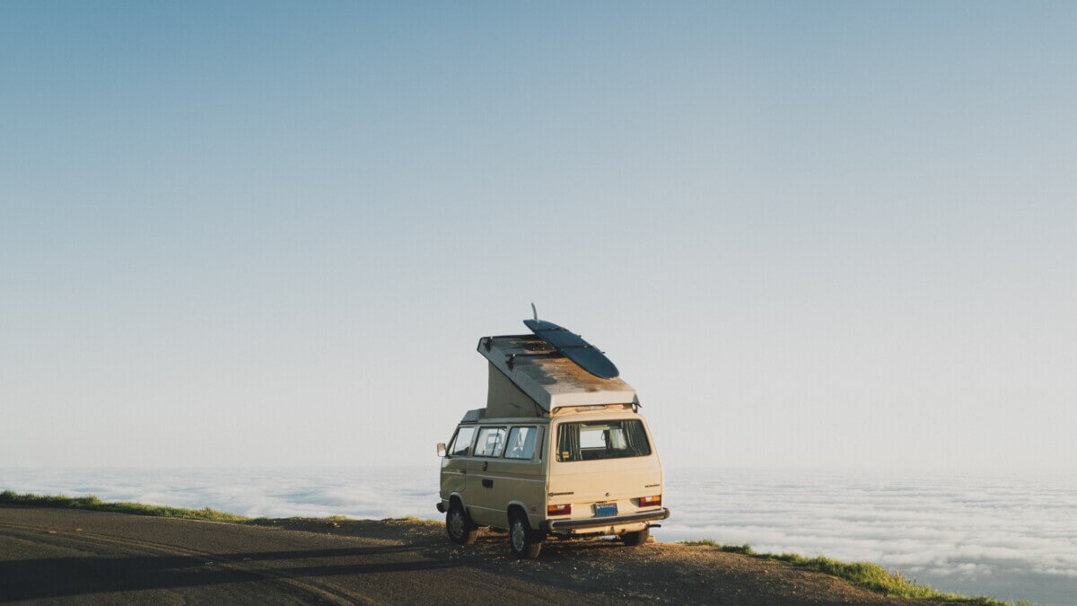 Van life: Nomads with van parked in front of ocean