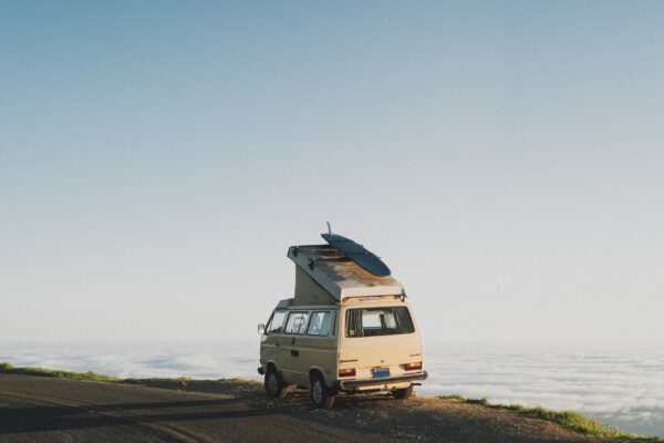 Van life: Nomads with van parked in front of ocean