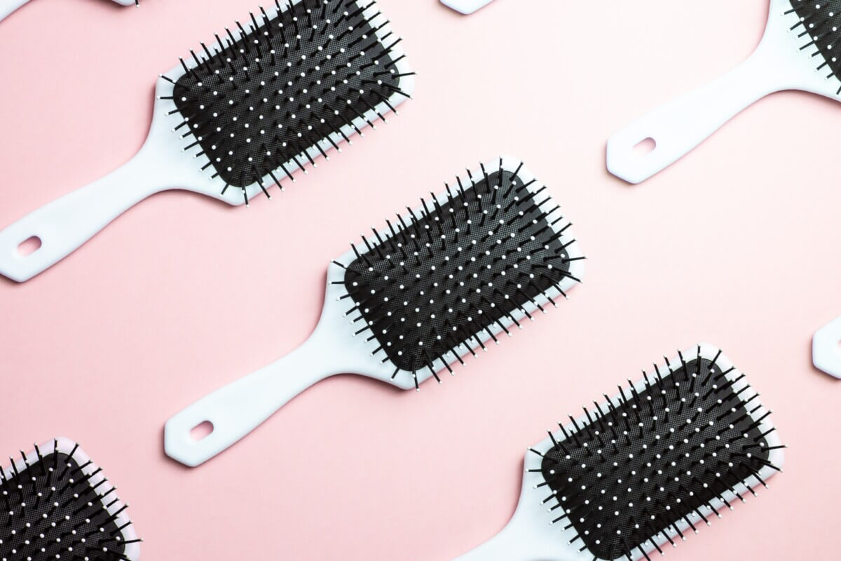 Hair brushes on a pink background