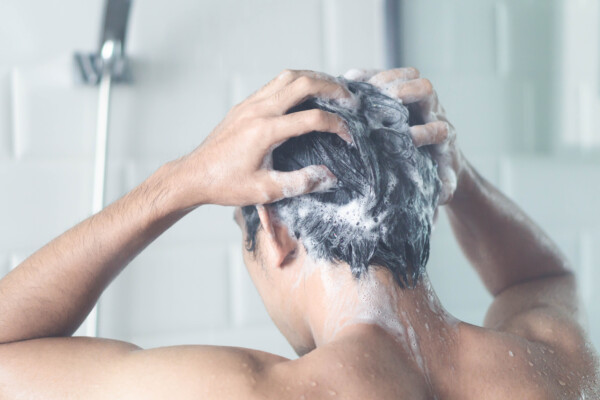 Man shampooing his hair in the shower
