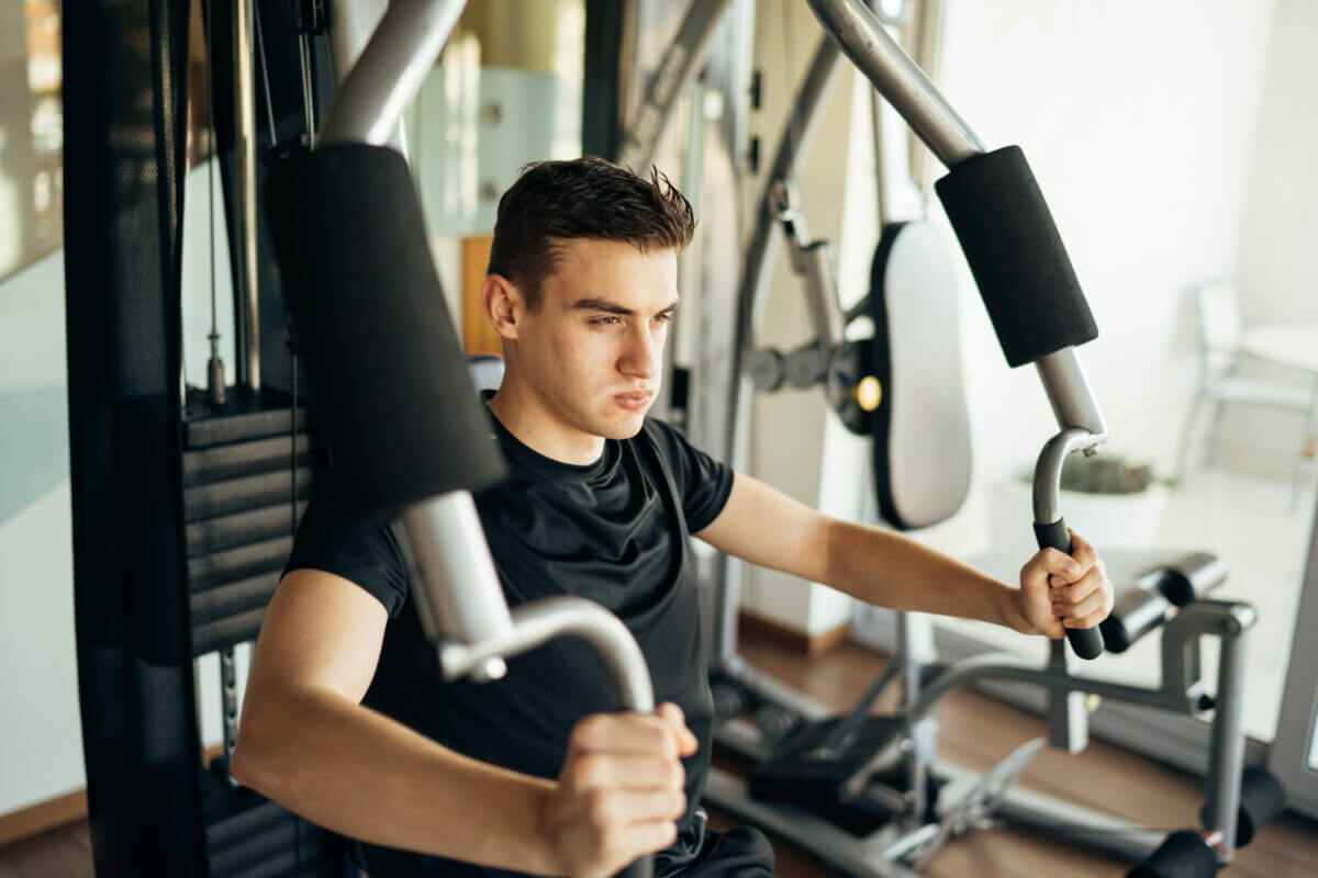 Man working out and lifting weights on his home gym