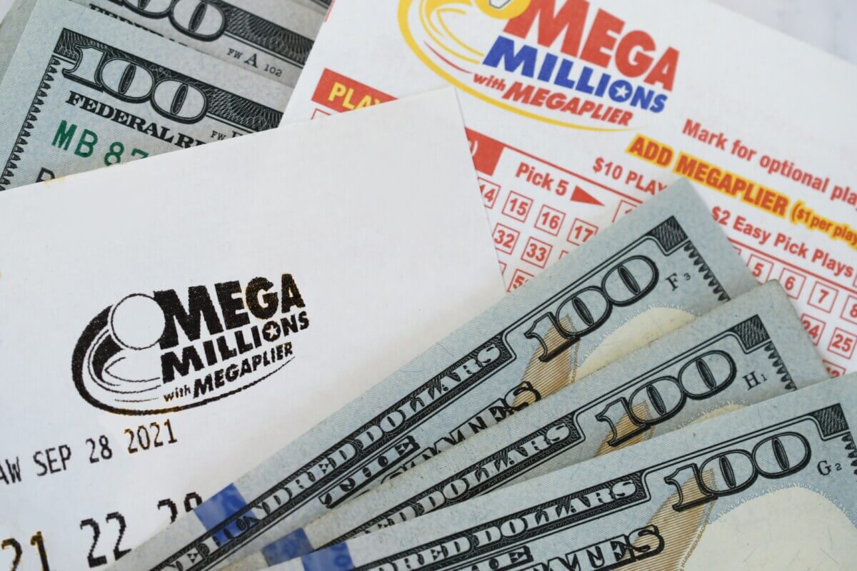 Mega Millions ticket with hundred dollar bills