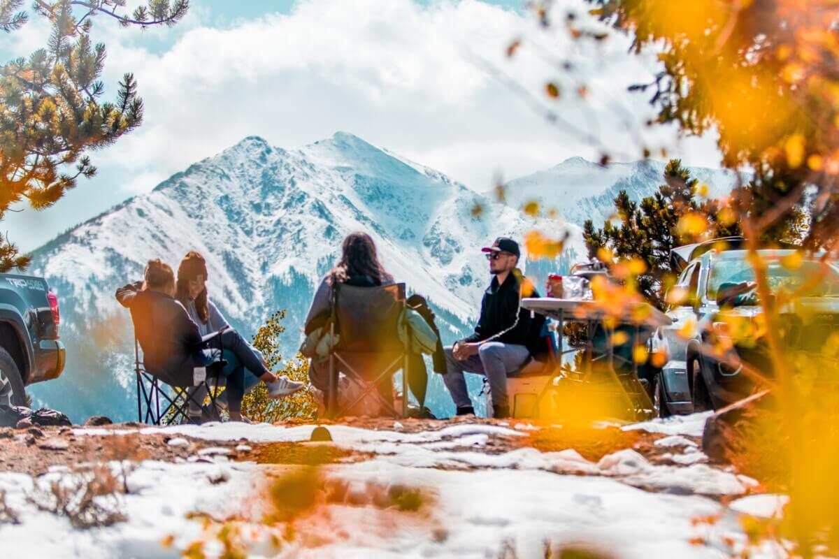 People sitting around a campsite in the forest