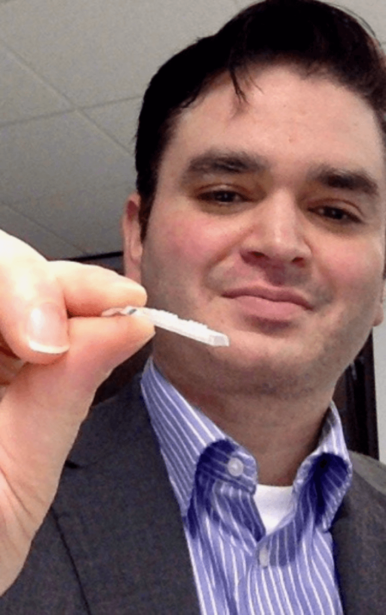 A doctor holds a small white patch that detects signs of Alzheimer's.