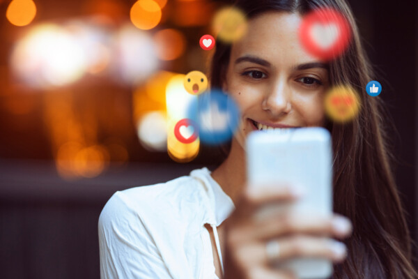 Teen girl smiling while looking at social media on her smatphone