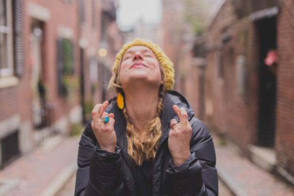 Woman crossing her fingers for good luck and great expectations