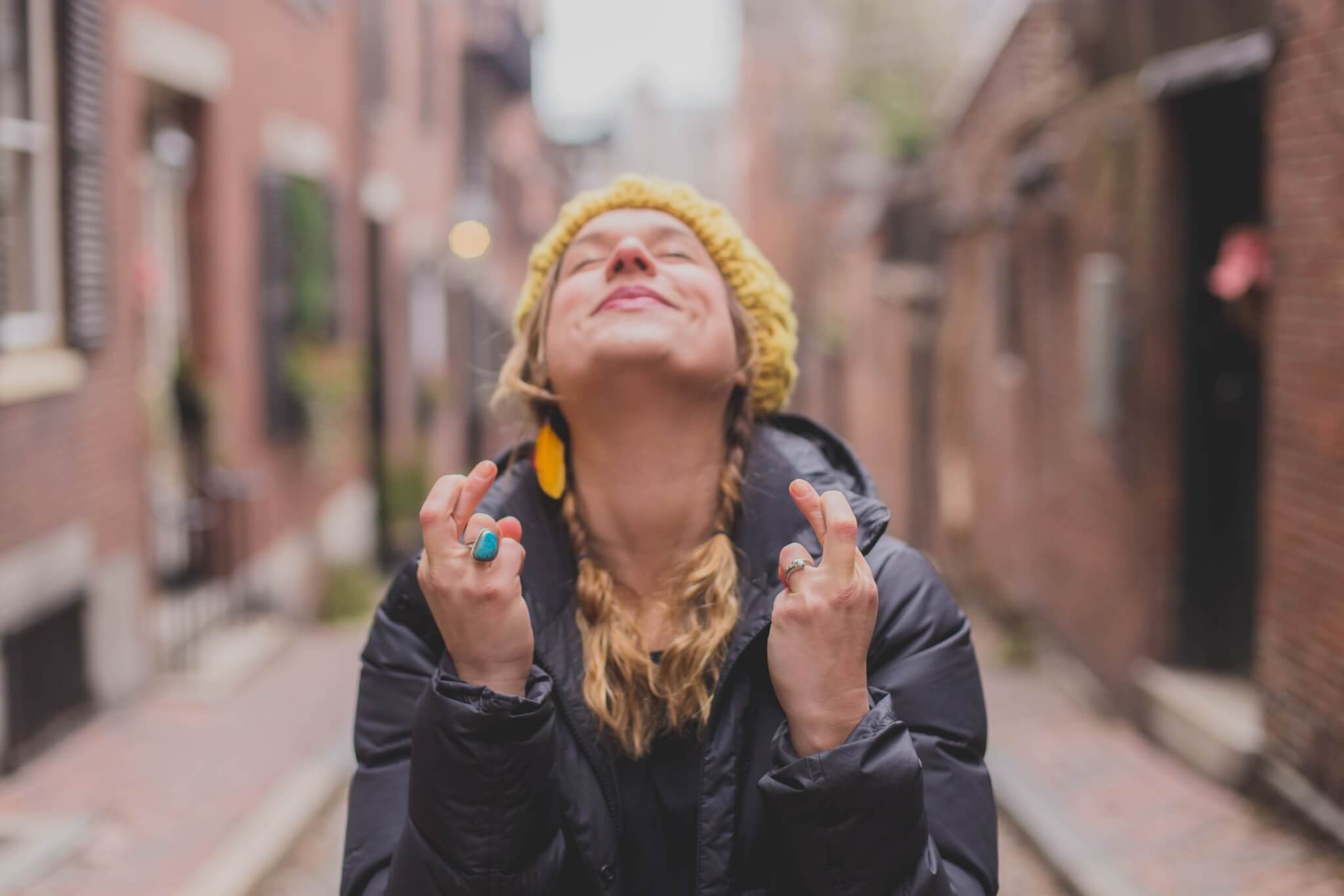 Woman crossing her fingers for good luck and great expectations