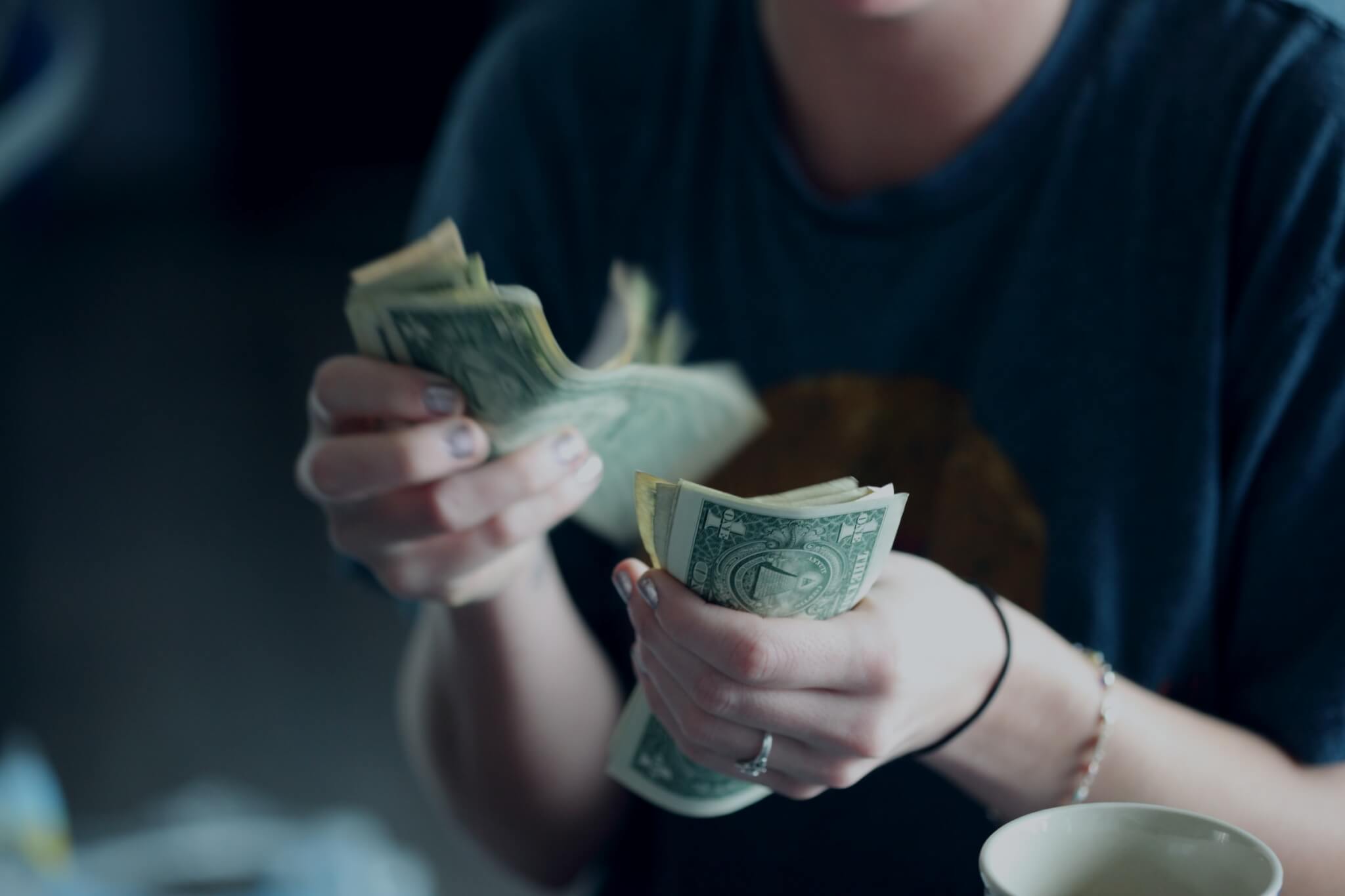 A person holding dollar bills