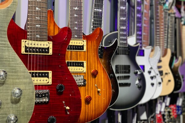 A row of electric guitars at a store