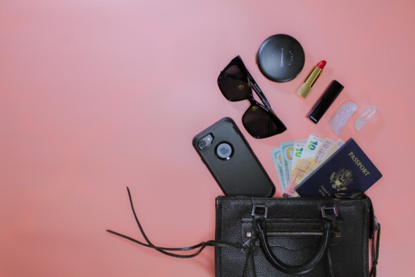 travel essentials falling out of a purse