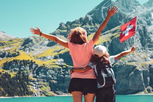 A mother and daughter in Switzerland with a Swiss flag