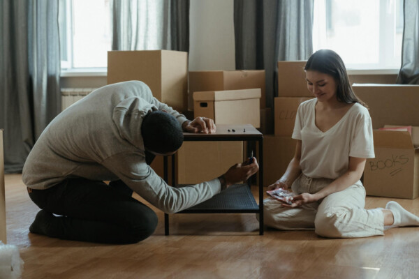 Man and woman building a table