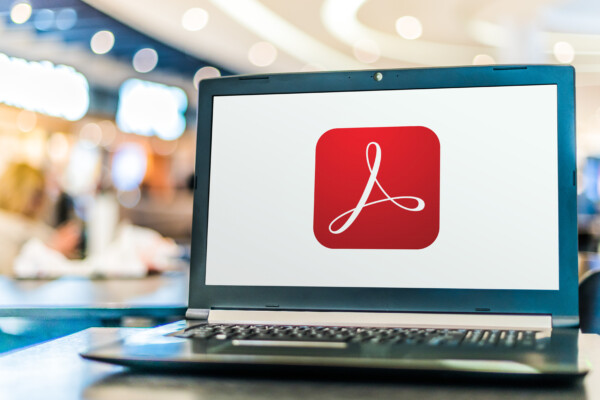 Laptop computer displaying logo of Adobe Acrobat