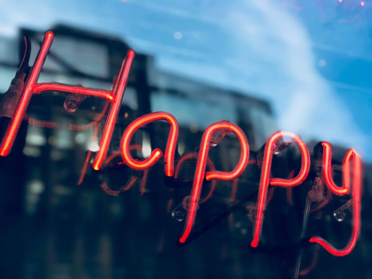 Neon lights that say “Happy”