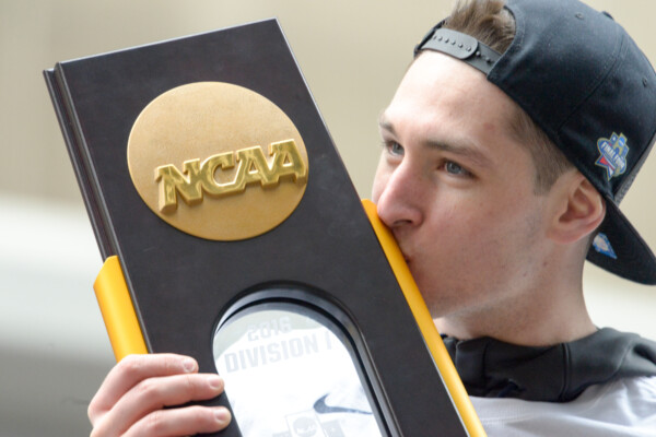 Ryan Arcidiacono of the 2016 National Champion Villanova Wildcats kisses the NCAA Championship trophy during the celebratory parade in Philadelphia.