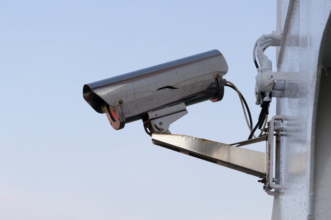 silver security camera attached to wall