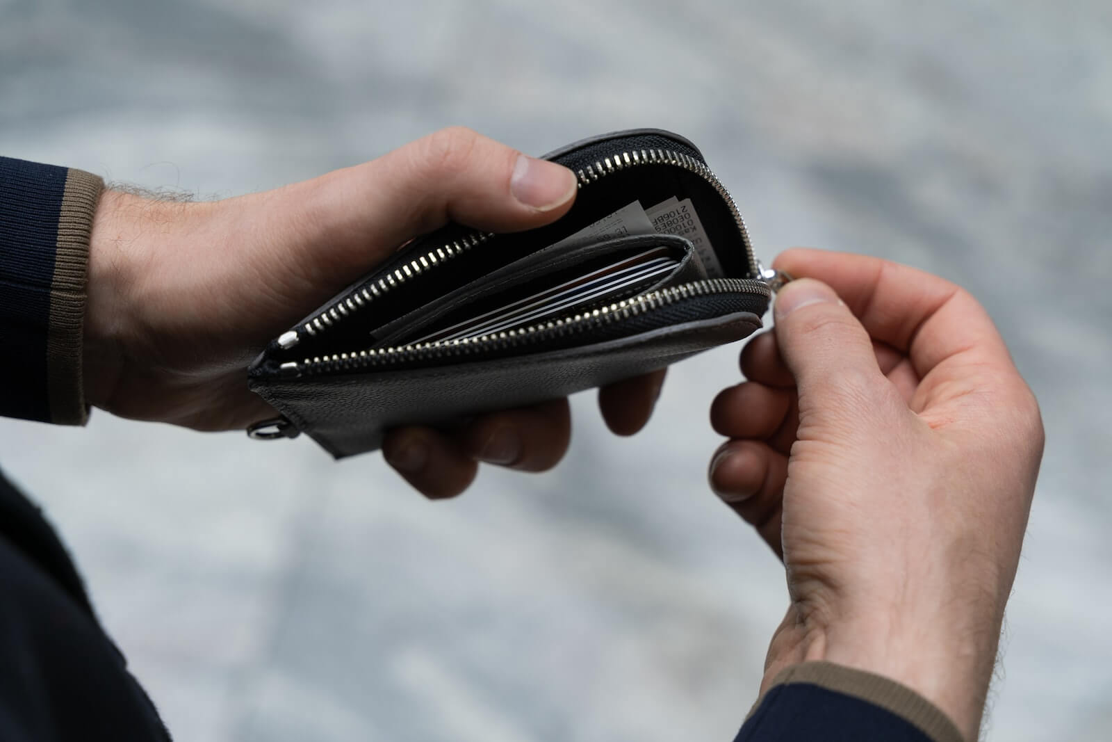 A man holding a wallet in his hand