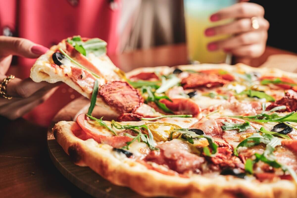 Woman eating a slice of pizza