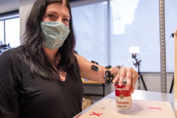 Woman picks up can after spinal stimulation to recover from stroke